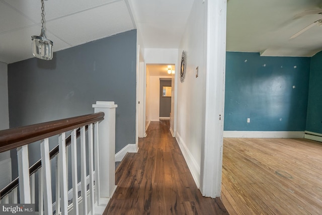 hall featuring dark wood-type flooring and vaulted ceiling