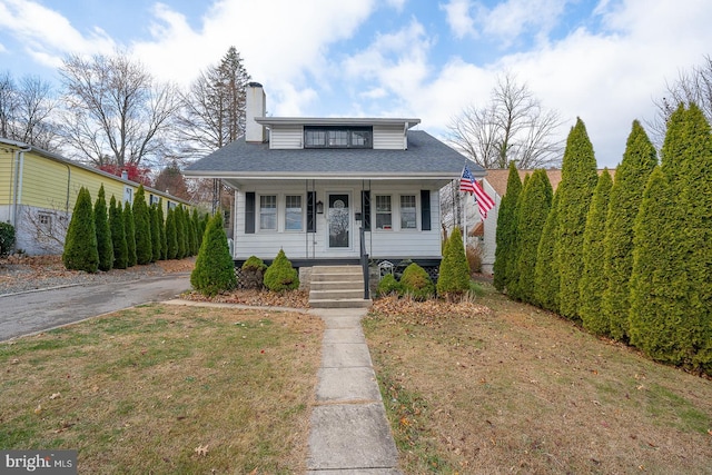 bungalow-style house with a front yard and a porch