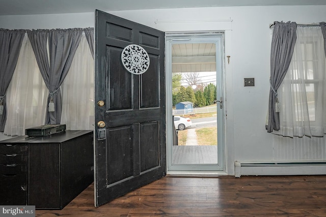 foyer entrance featuring dark hardwood / wood-style flooring and a baseboard radiator