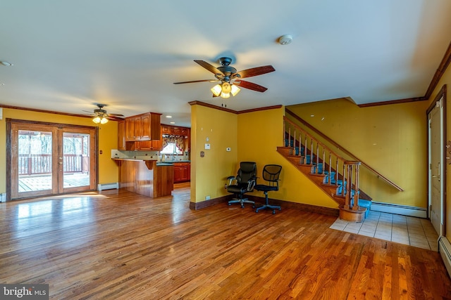 unfurnished living room with baseboard heating, ceiling fan, light hardwood / wood-style floors, and ornamental molding