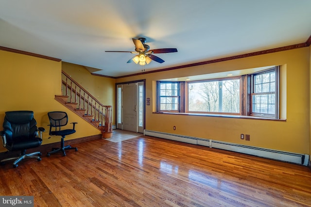 foyer entrance featuring hardwood / wood-style floors, a baseboard radiator, ceiling fan, and ornamental molding