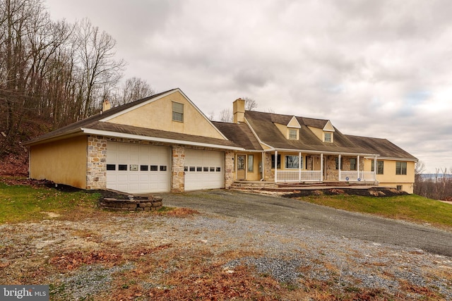 view of front facade with a garage and covered porch