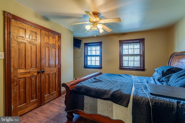 bedroom with ceiling fan and dark wood-type flooring