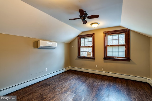 additional living space with a wall mounted air conditioner, a baseboard heating unit, dark hardwood / wood-style flooring, and lofted ceiling