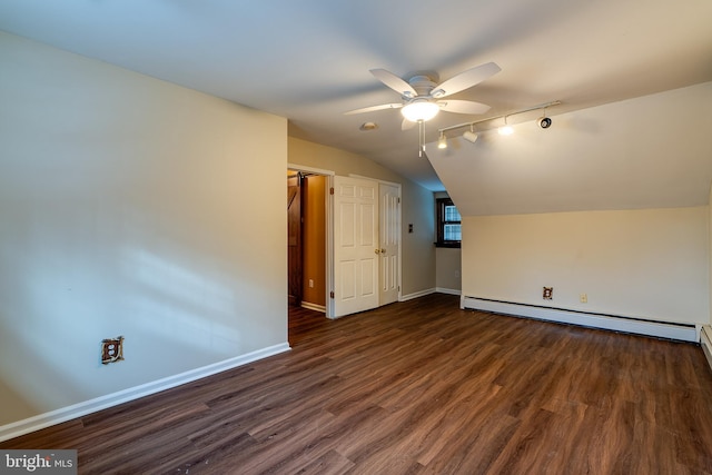 additional living space featuring ceiling fan, dark hardwood / wood-style flooring, lofted ceiling, and a baseboard heating unit