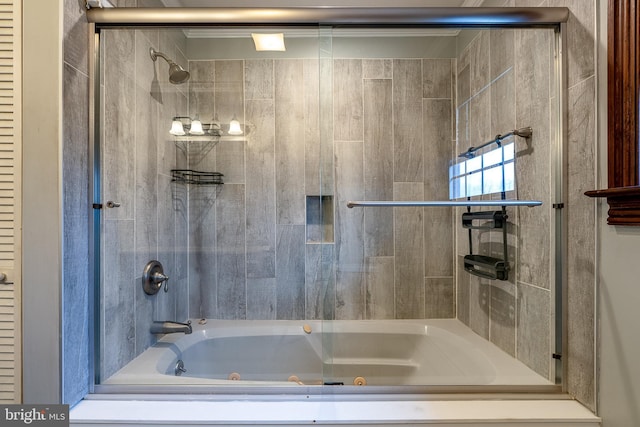 bathroom featuring bath / shower combo with glass door