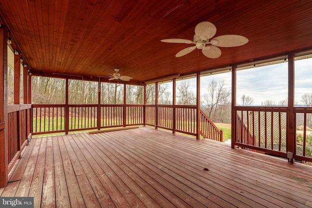 unfurnished sunroom with ceiling fan and wooden ceiling