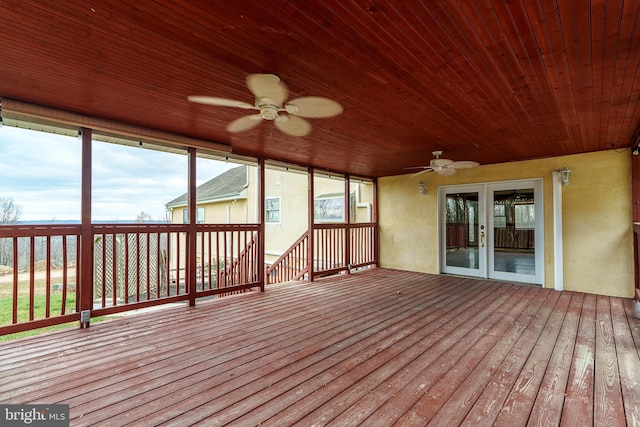 unfurnished sunroom with ceiling fan and wood ceiling