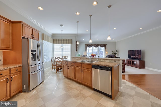 kitchen featuring light stone countertops, sink, stainless steel appliances, decorative light fixtures, and ornamental molding