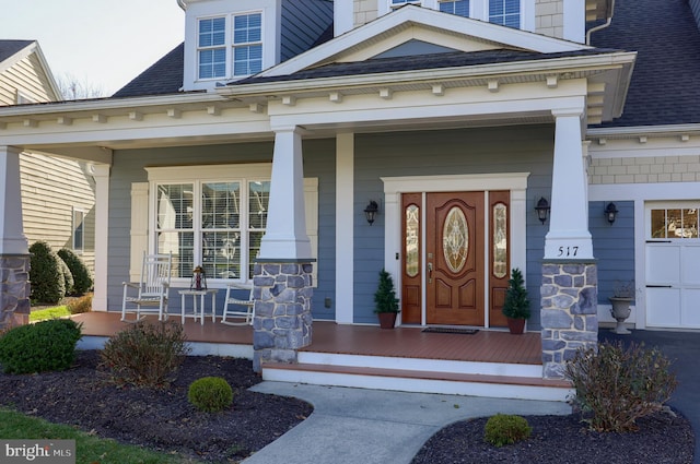 view of exterior entry with covered porch