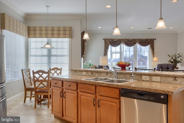 kitchen featuring pendant lighting, ornamental molding, sink, and appliances with stainless steel finishes