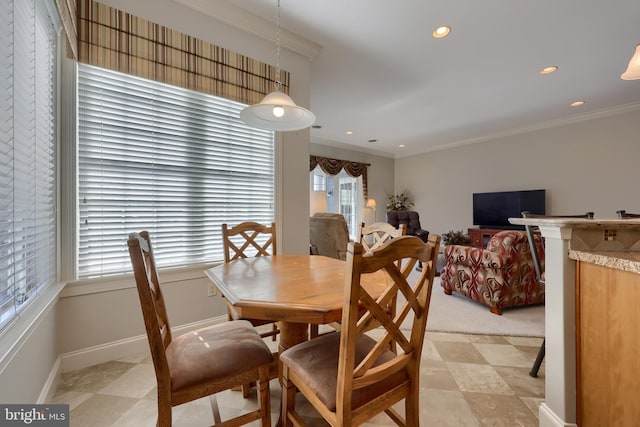 dining room with plenty of natural light and crown molding