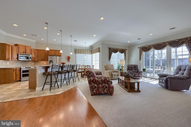 living room featuring light hardwood / wood-style floors and crown molding