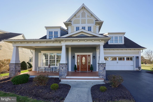 craftsman-style house featuring covered porch and a garage