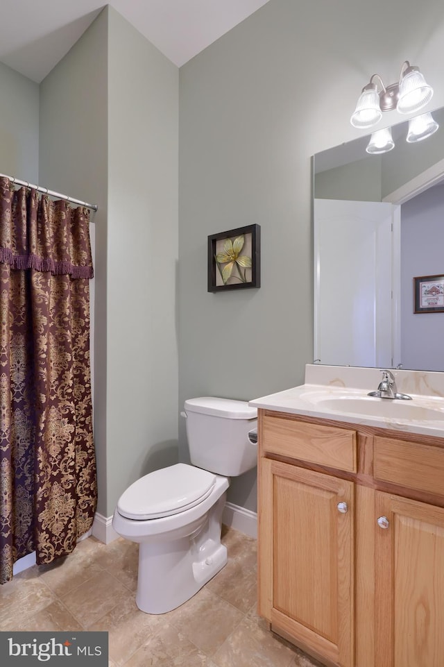 bathroom featuring tile patterned floors, vanity, and toilet