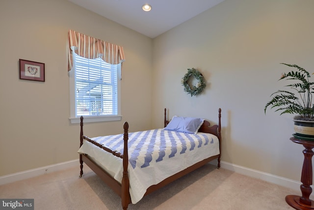 bedroom featuring light colored carpet