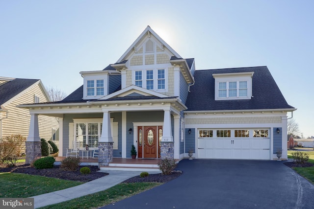 craftsman inspired home with covered porch and a garage