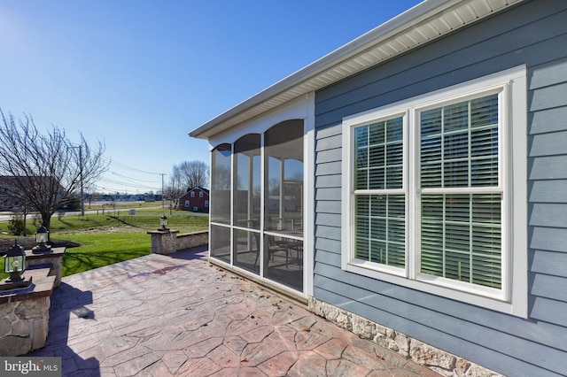 view of patio with a sunroom