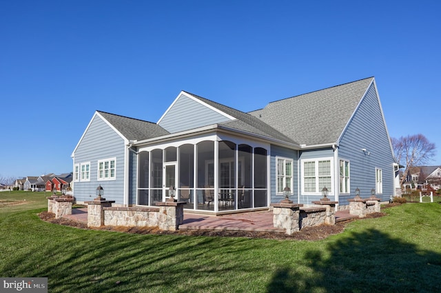 back of house with a yard, a patio, and a sunroom