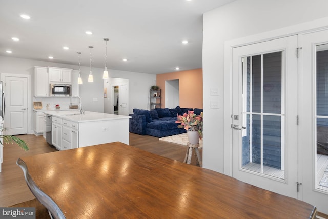 dining area featuring light wood-type flooring and sink