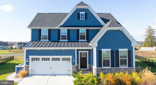 craftsman house with a front lawn and a garage