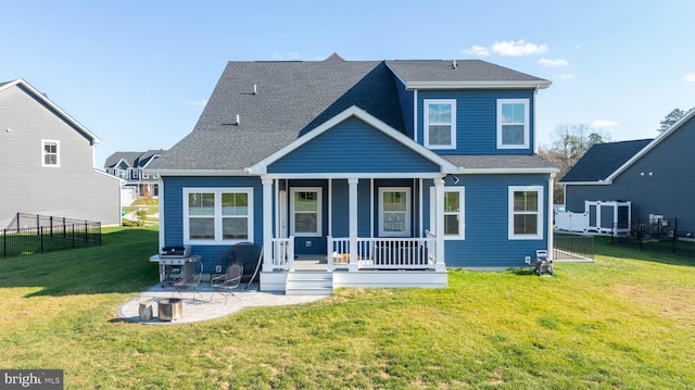 back of house featuring a lawn and covered porch