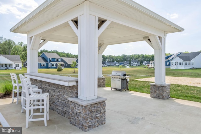 view of patio with a gazebo, a grill, and an outdoor bar