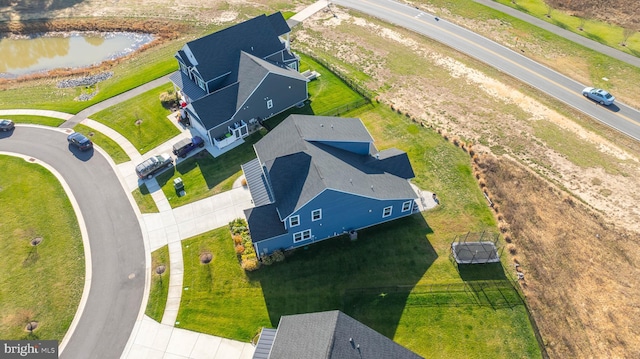 birds eye view of property with a water view