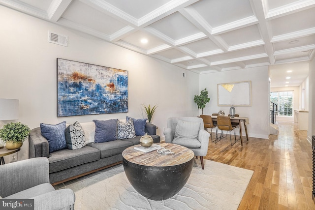 living room with beamed ceiling, wood-type flooring, crown molding, and coffered ceiling