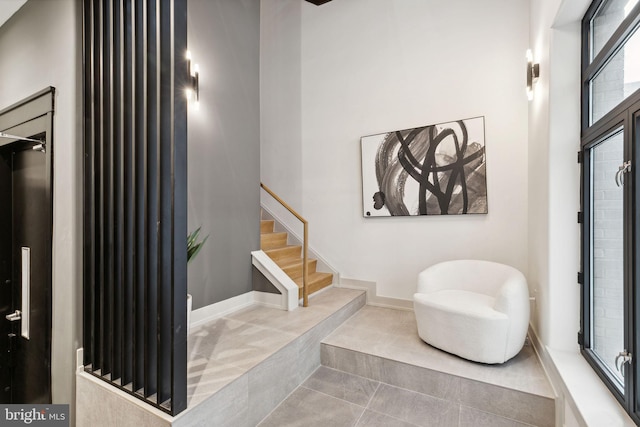 tiled entrance foyer with a high ceiling