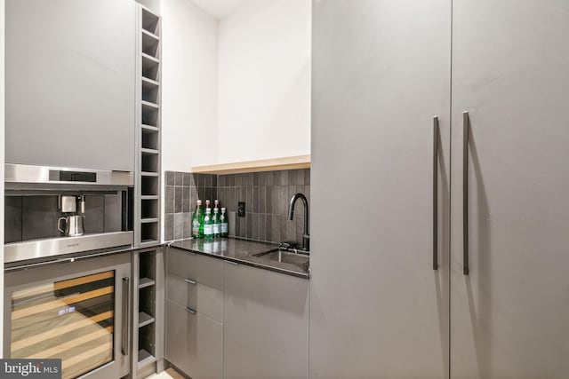 kitchen with sink, beverage cooler, white refrigerator, oven, and decorative backsplash