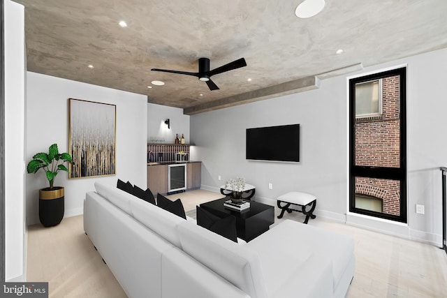 living room with ceiling fan, light hardwood / wood-style flooring, and beverage cooler