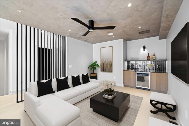 living room featuring ceiling fan, light wood-type flooring, and beverage cooler