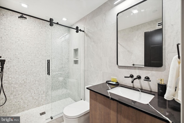 bathroom with backsplash, an enclosed shower, vanity, tile walls, and toilet