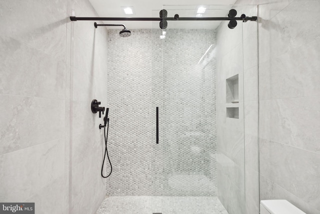 bathroom with a shower with shower door