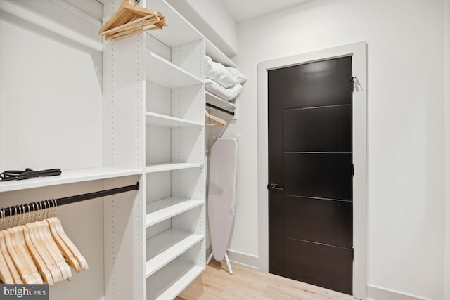 walk in closet featuring light hardwood / wood-style floors