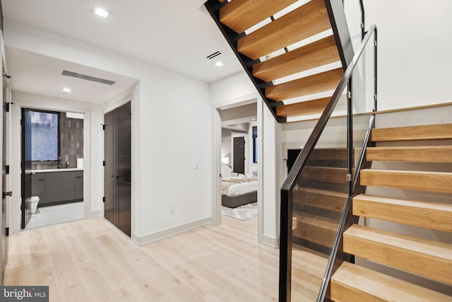 stairs with wood-type flooring