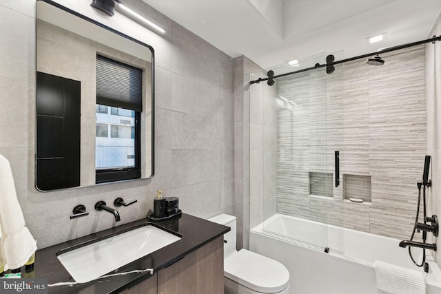 full bathroom with backsplash, bath / shower combo with glass door, toilet, vanity, and tile walls