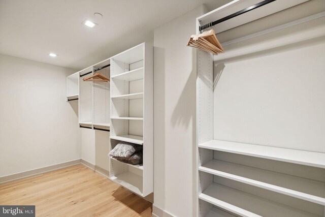 walk in closet featuring light hardwood / wood-style flooring