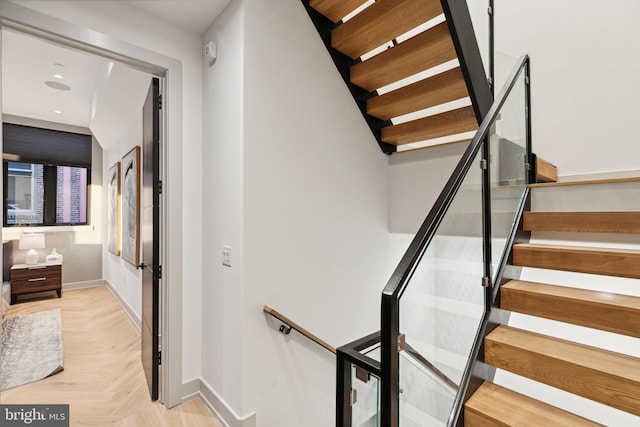 staircase featuring parquet floors