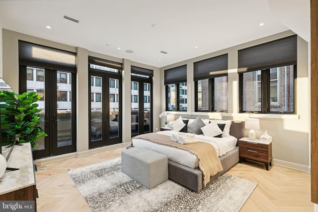 bedroom with light parquet floors, multiple windows, access to outside, and french doors