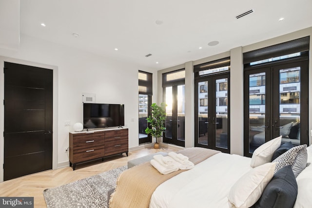 bedroom featuring french doors, light parquet flooring, and access to outside