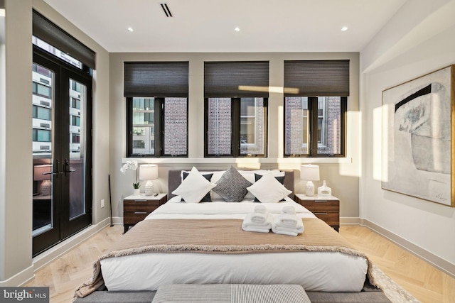 bedroom with light parquet floors and french doors