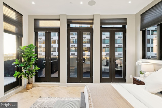 interior space featuring parquet flooring, french doors, and multiple windows