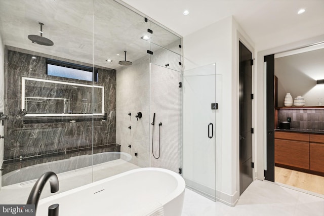 bathroom featuring plus walk in shower and tile patterned flooring