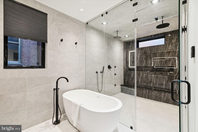 bathroom featuring tile patterned floors, tile walls, and independent shower and bath