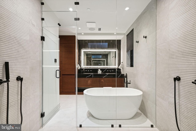 bathroom with tile patterned flooring, independent shower and bath, and tile walls