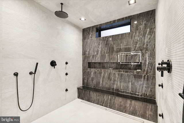 bathroom featuring tile patterned flooring and tiled shower