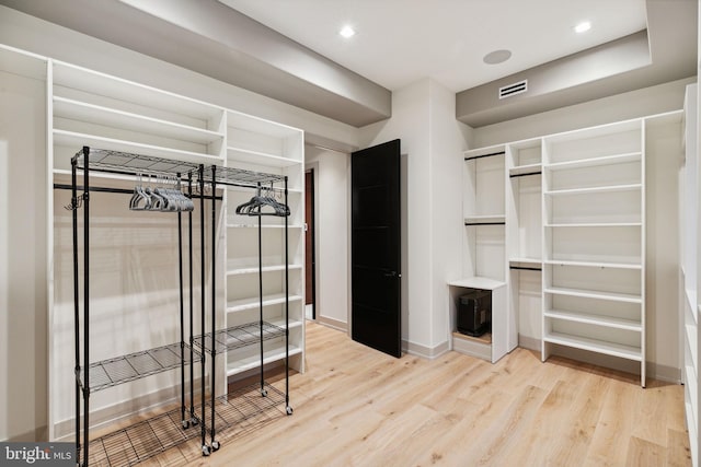 spacious closet featuring light hardwood / wood-style floors