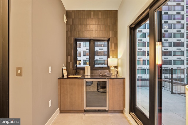 bar featuring light tile patterned floors and wine cooler